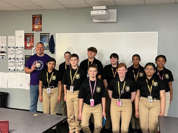 Smith-Cotton Junior High JROTC students celebrated Military Appreciation Day by giving staff members who serve or have served in the military a gift.